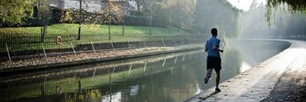 Man jogging by a river