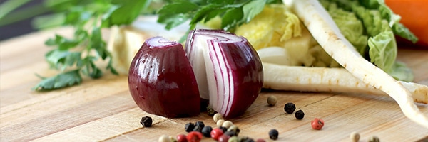 Onion and black peppercorns on a table