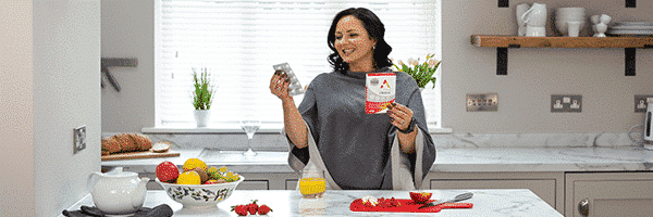 Woman holding a box of Active Iron