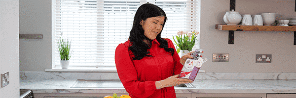 Woman holding a box of Active Iron