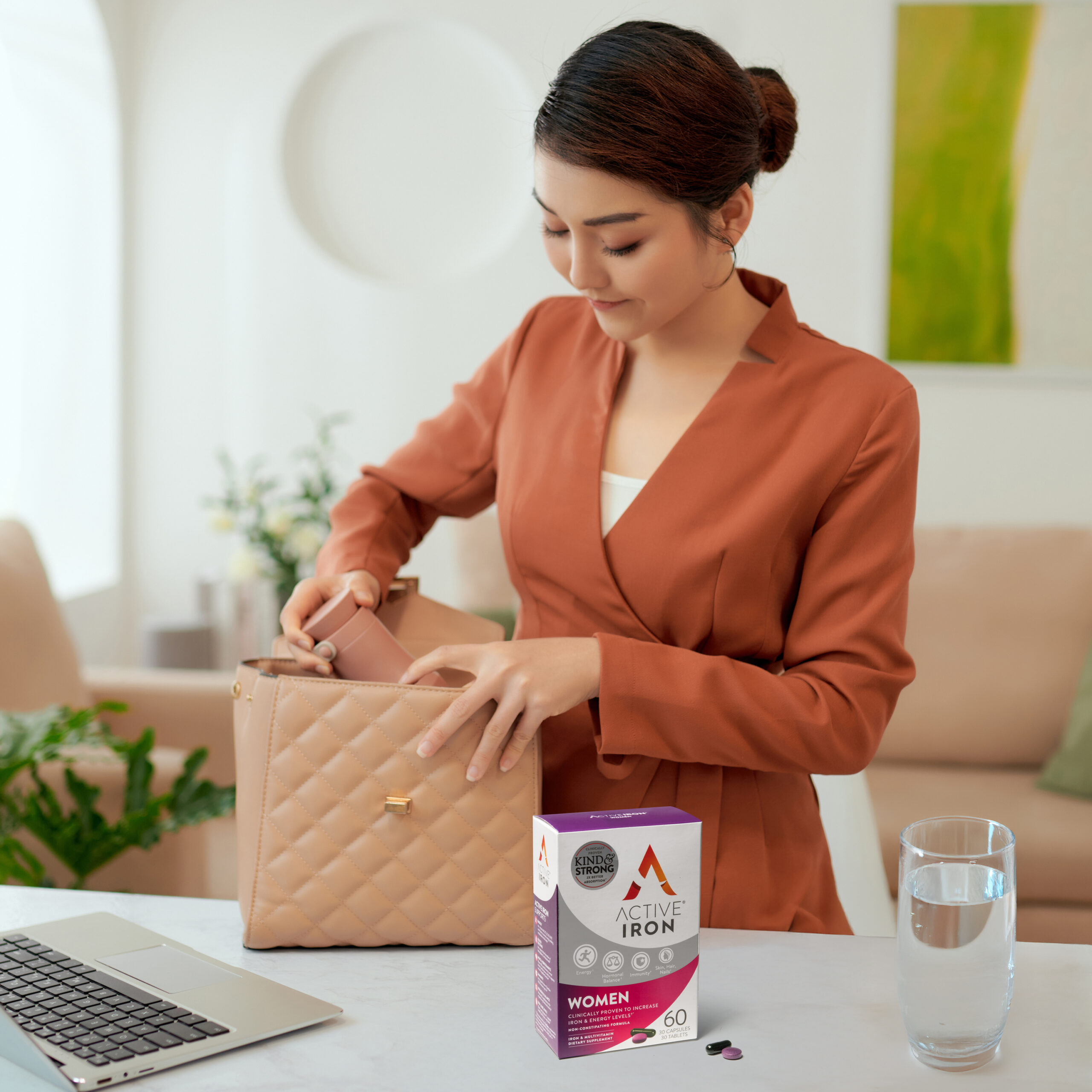 Businesswoman putting essential things into her handbag,