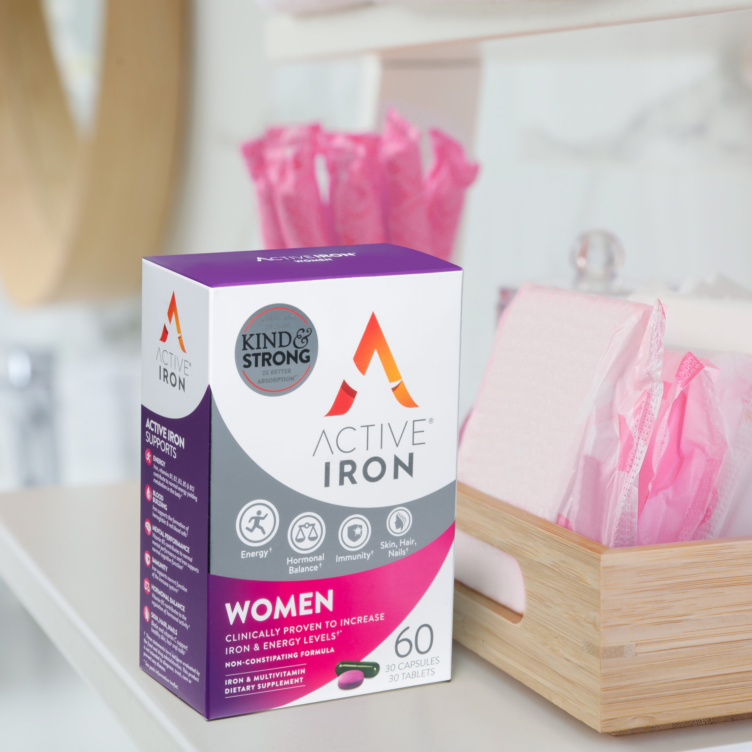 Organizer with tampons and menstrual pads on shelving unit in bathroom. Feminine hygiene products